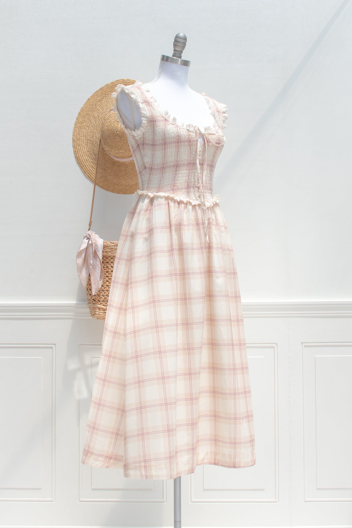 Beige plaid cotton smocked dress displayed on a mannequin, three quarter view.