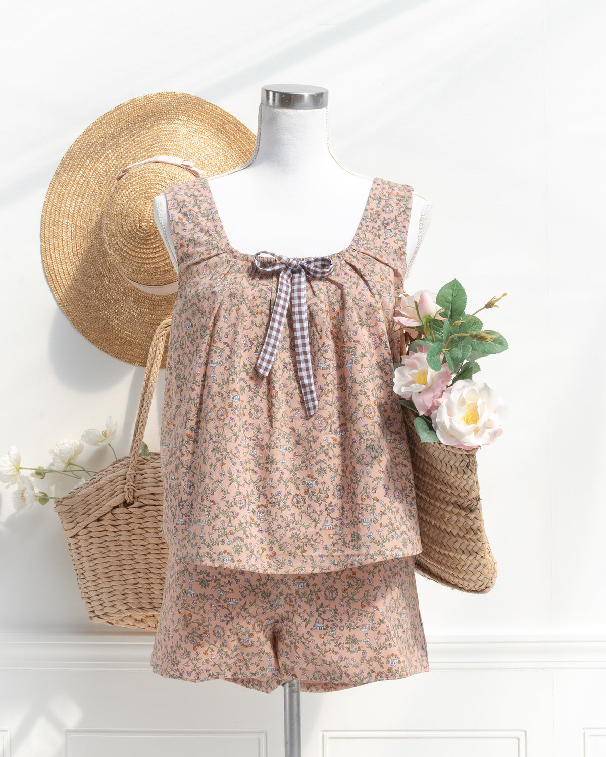 Blush floral print lounge set with gingham bow detail, mannequin front view.