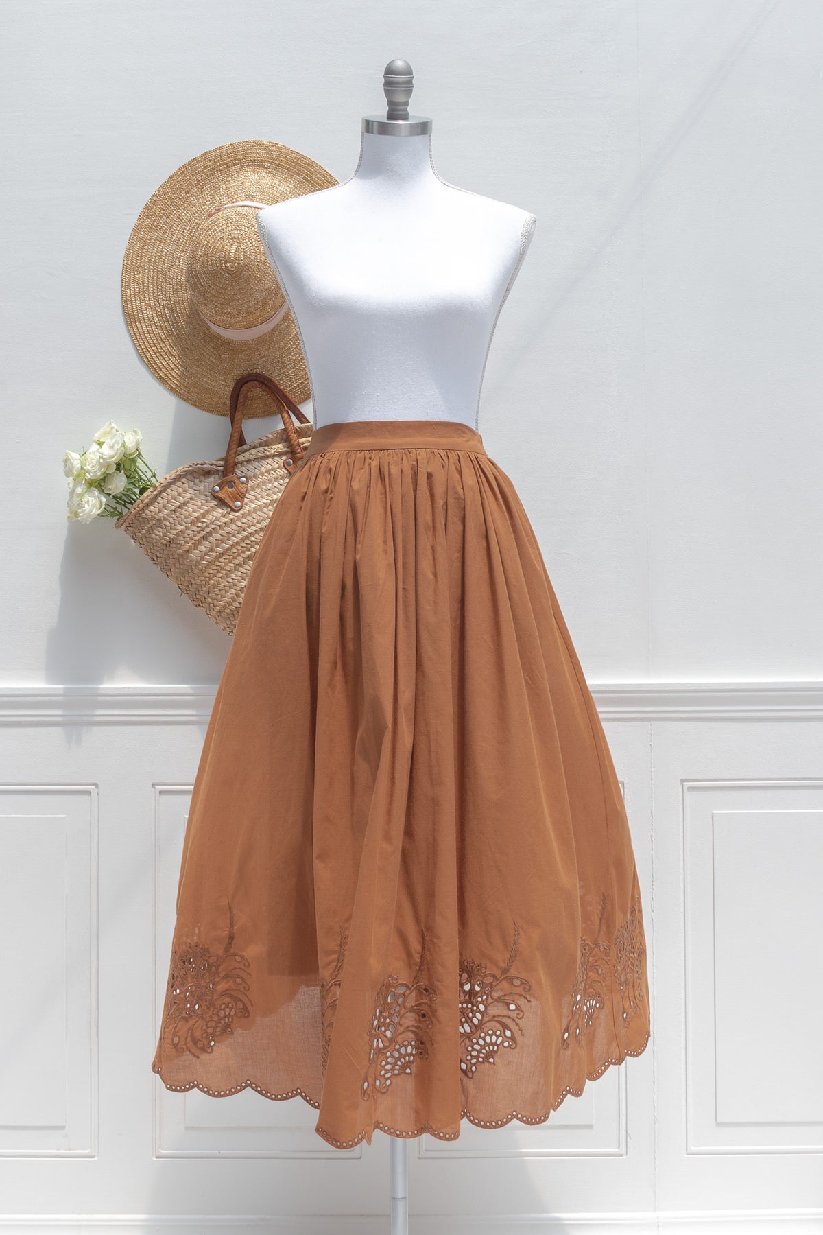 Flowing chestnut cotton midi skirt with embroidered hem.