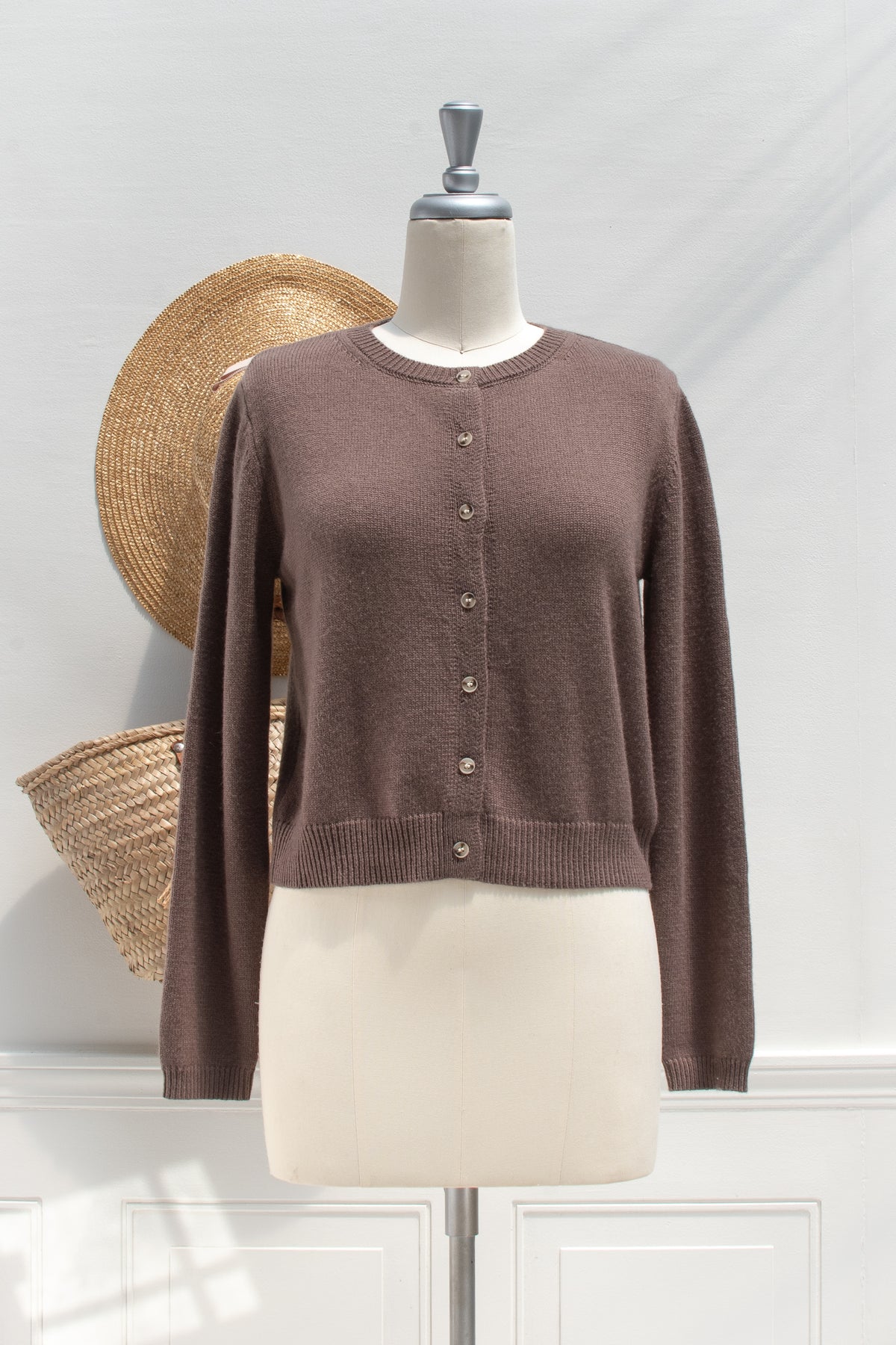 Brown round neck cardigan shown buttoned on a mannequin, front view, a French girl essential.