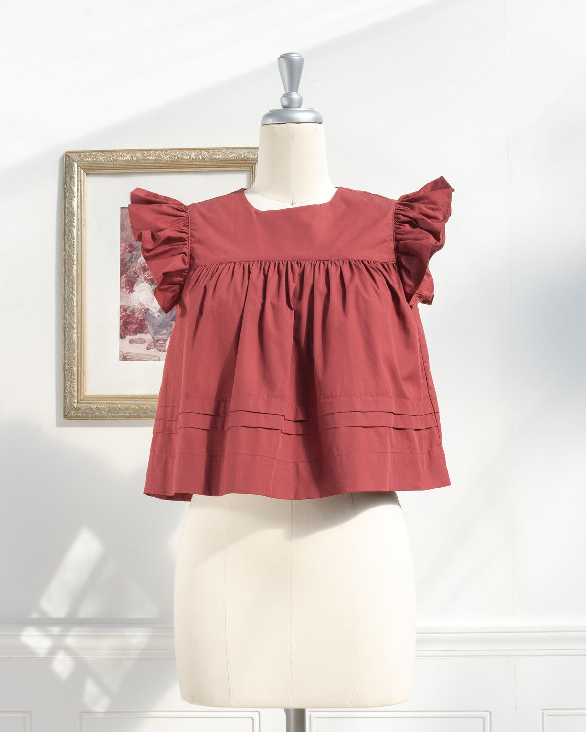 Burgundy cotton flutter sleeve top with pintuck hem. French feminine style clothing, front view.