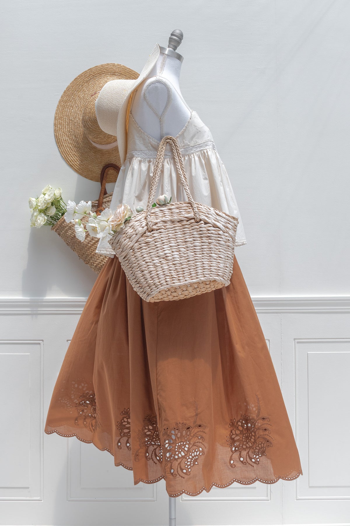 Chestnut cotton midi skirt styled with a cropped top and straw basket, side view.