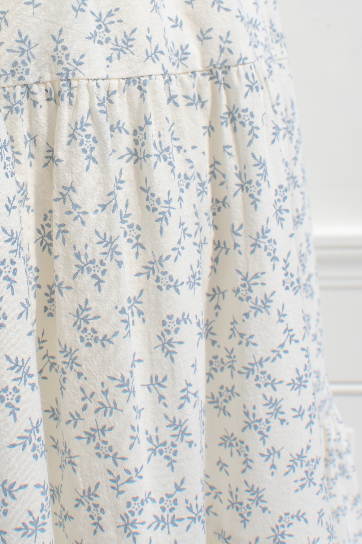 Ivory cotton fabric with blue floral print — texture detail