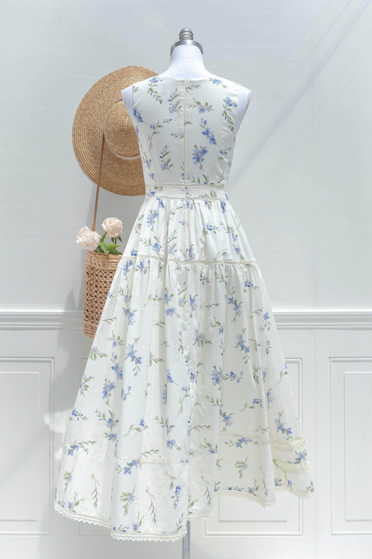Cream blue floral cotton midi dress with structured back bodice and lace hem detail back view.