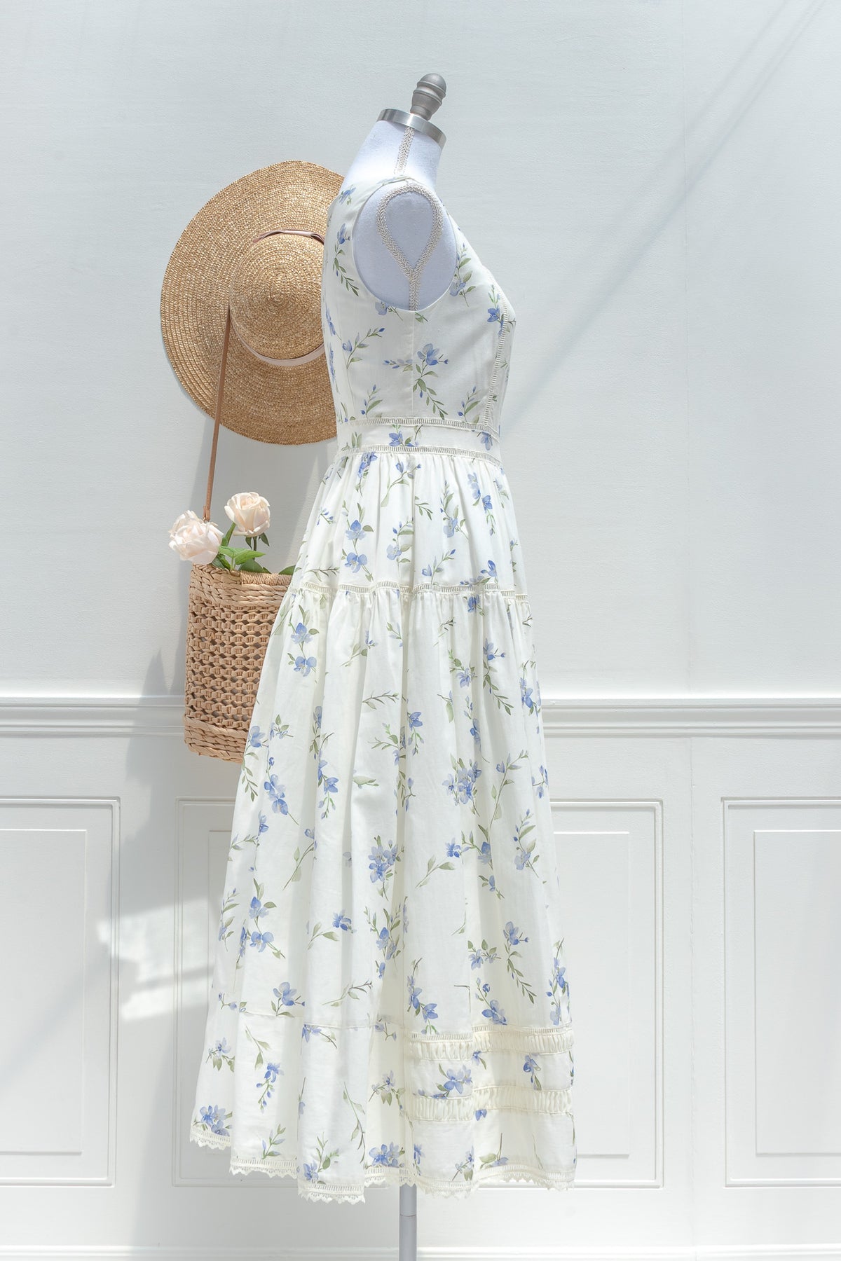 Cream blue floral cotton midi dress with full tiered skirt and delicate lace hem side view.