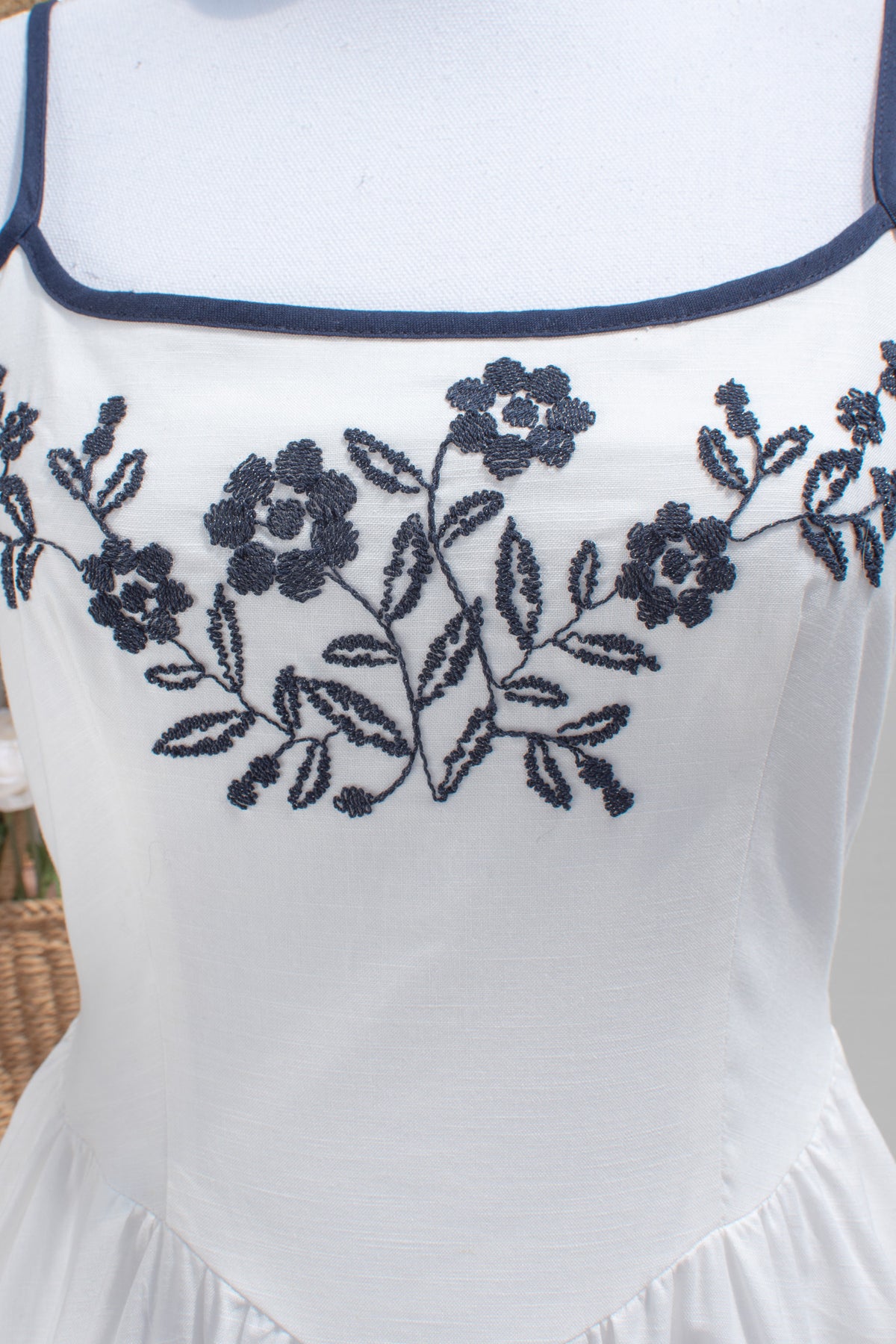 close up of bust navy blue trim and embroidery