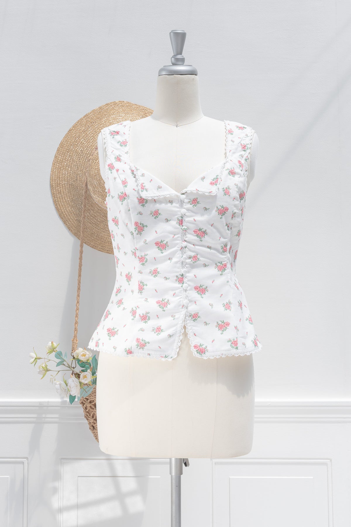 White floral linen cotton bustier top with sweetheart neckline, button front and scalloped lace hem, front view.
