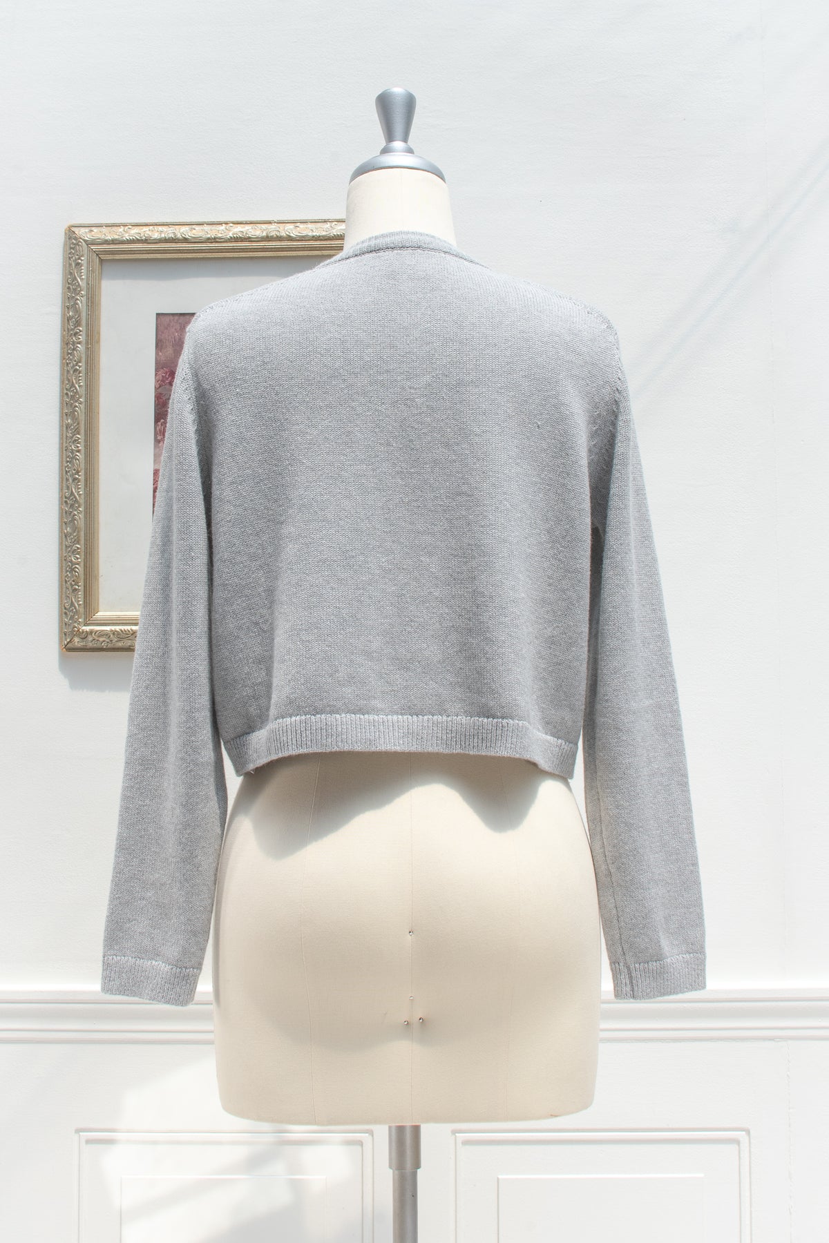 Gray cotton wool cropped cardigan displayed on a mannequin, back view.
