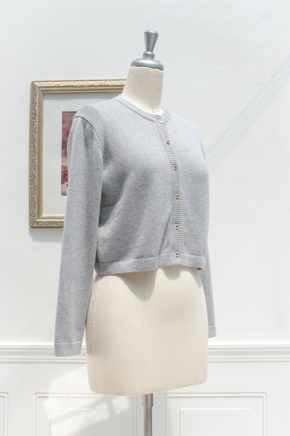 Gray cotton wool cropped cardigan displayed on a mannequin, three quarter view.