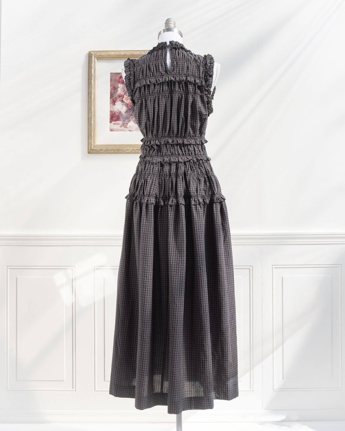 Gray plaid midi dress with keyhole back closure and smocked waist on a mannequin, French girl style, back view.