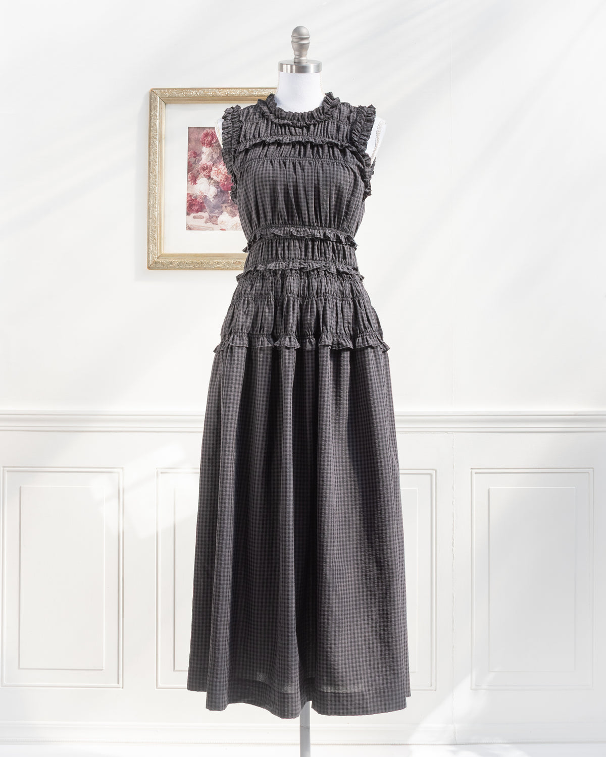 Gray plaid midi dress with smocked waist and ruffled high neckline on a mannequin, romantic French girl style, front view.