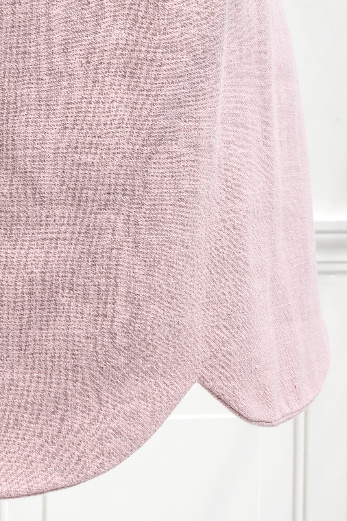 Scalloped hem detail on pink linen cotton mini dress
