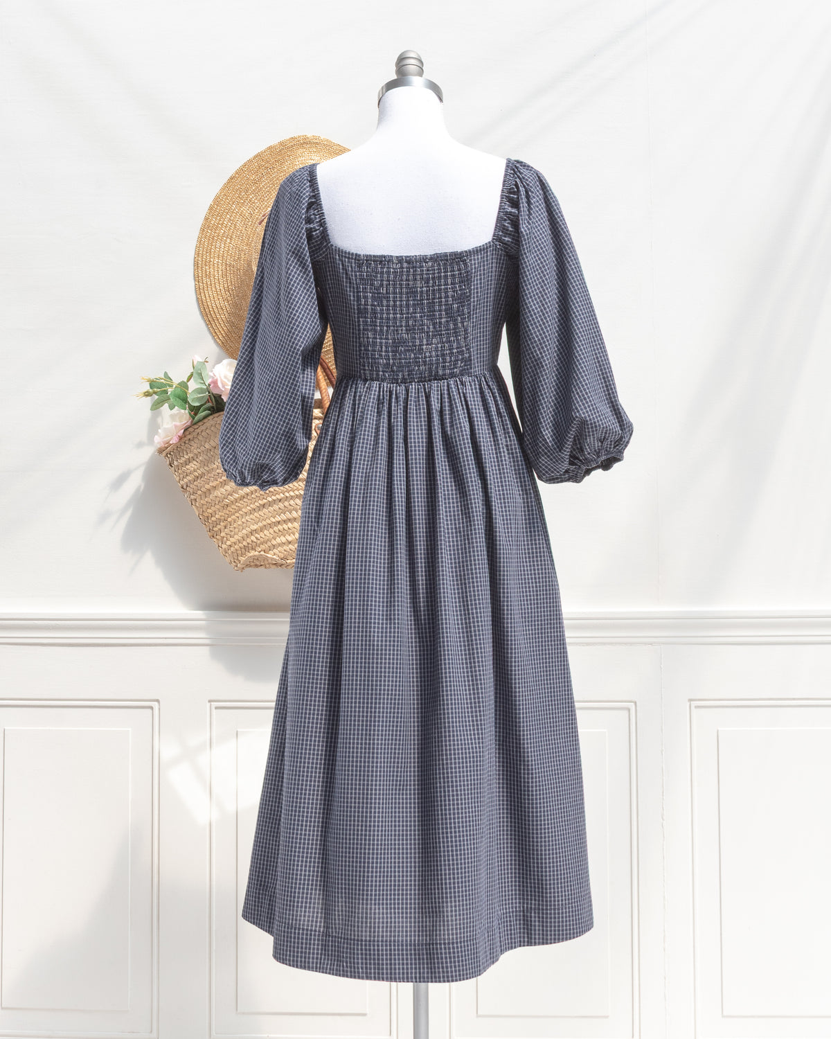 Navy check cotton midi dress with smocked back panel, mannequin back view.