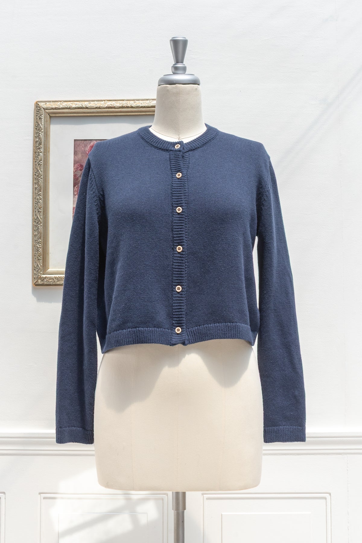 Navy cotton wool cropped cardigan displayed on a mannequin, front view.