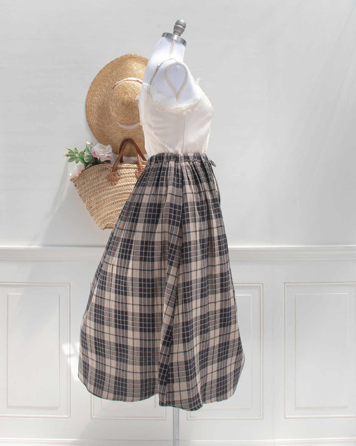 Tan and black plaid cotton midi skirt with full gathered shape, mannequin side view.