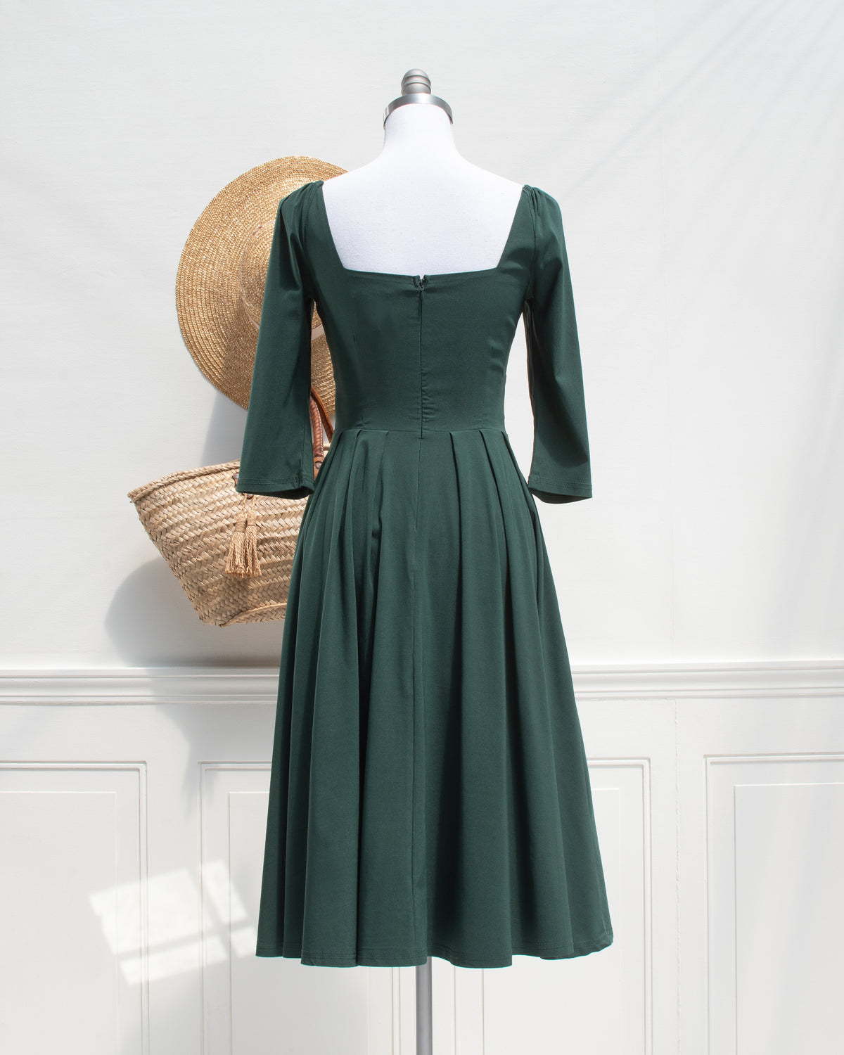 Green Retro Swing Dress. In French vintage style with modern ease featuring a sculpted sweetheart neckline, softly gathered shoulders, and a full swing skirt. back view. Amantine