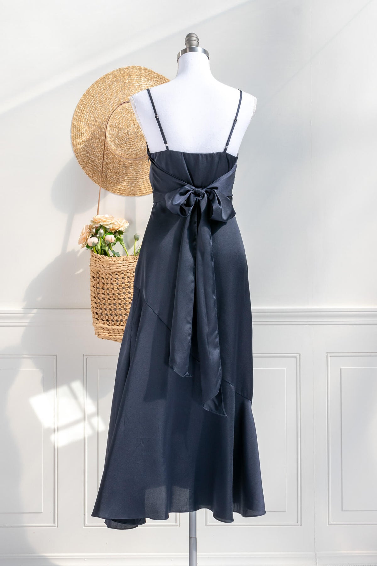 Beautiful wedding guest and formal dress in navy blue. French style feminine and romantic dress with straps, slit, and a bow. back view. Amantine dresses.