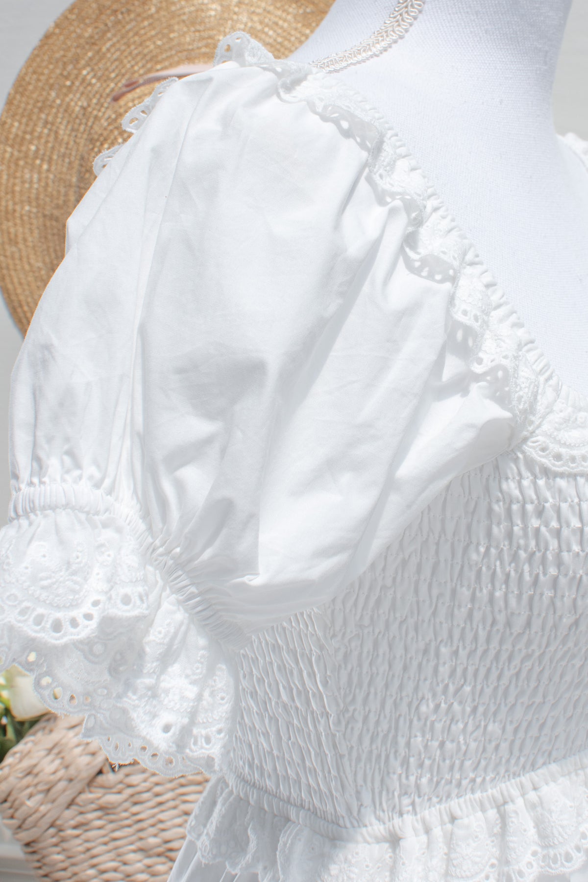 White cotton midi dress with eyelet lace puff sleeve closeup.