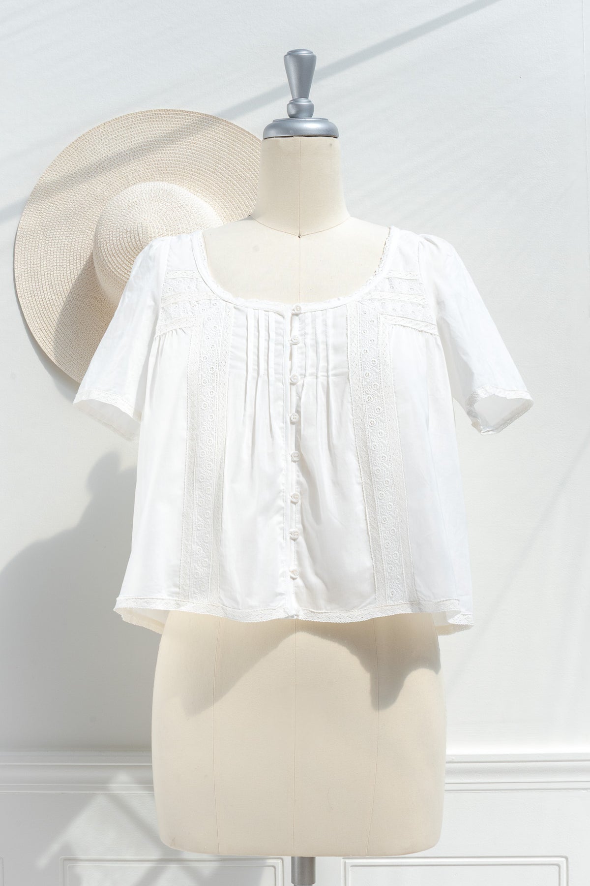 White cotton peasant blouse with pintuck detail lace trim and mother of pearl buttons front view