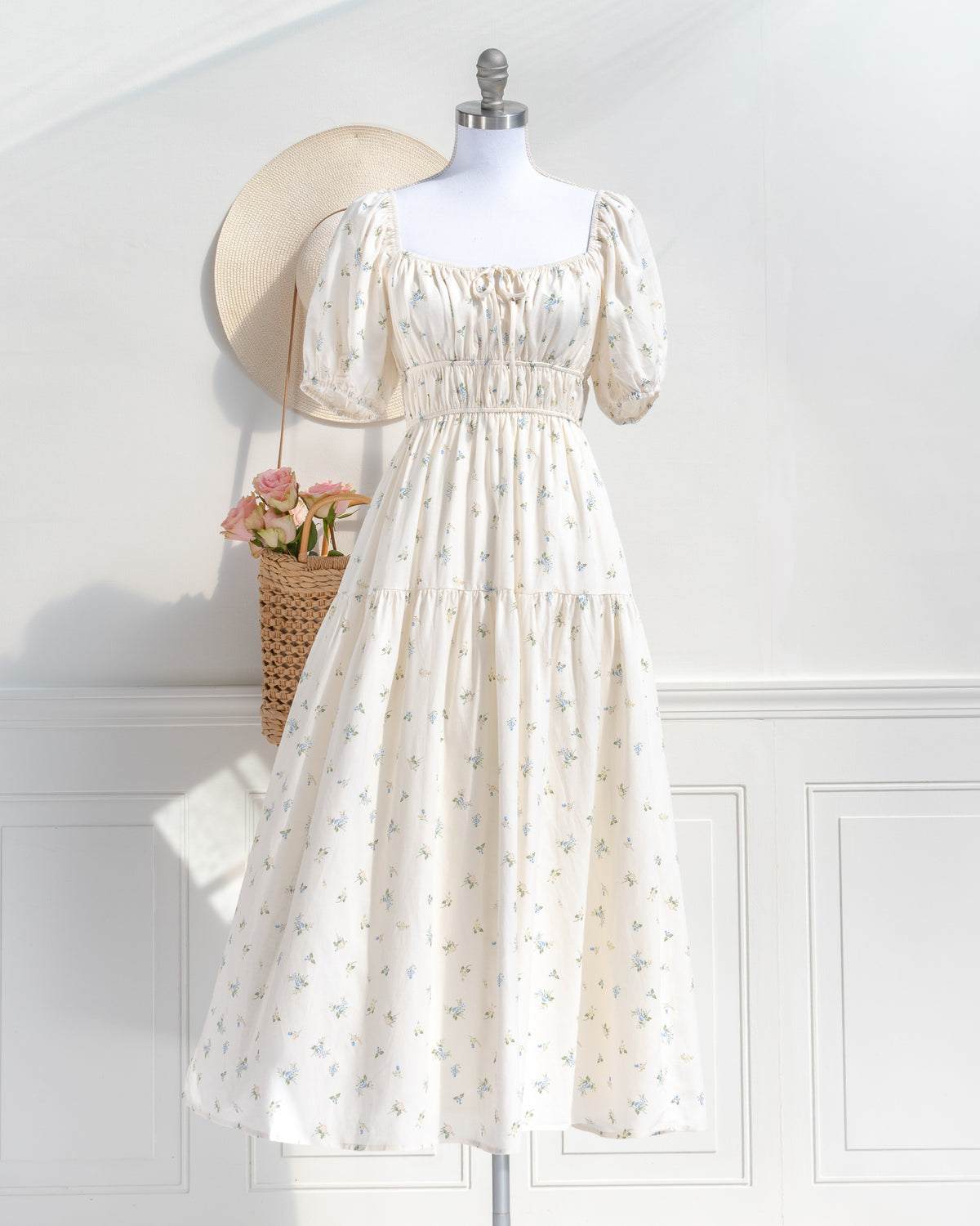 Front view of the Elisette dress, a vintage-inspired cream floral midi dress with puff sleeves and a square neckline.