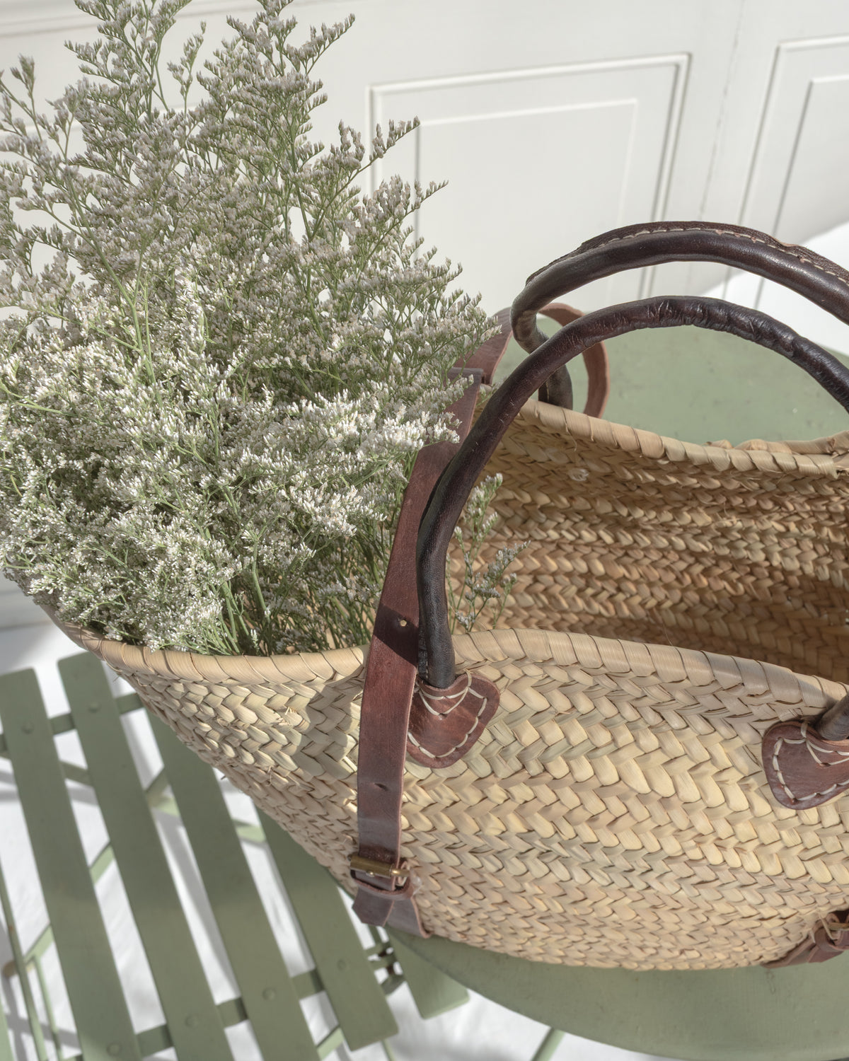 Looking into the open tote from above: a roomy woven interior beneath two rolled brown handles.
