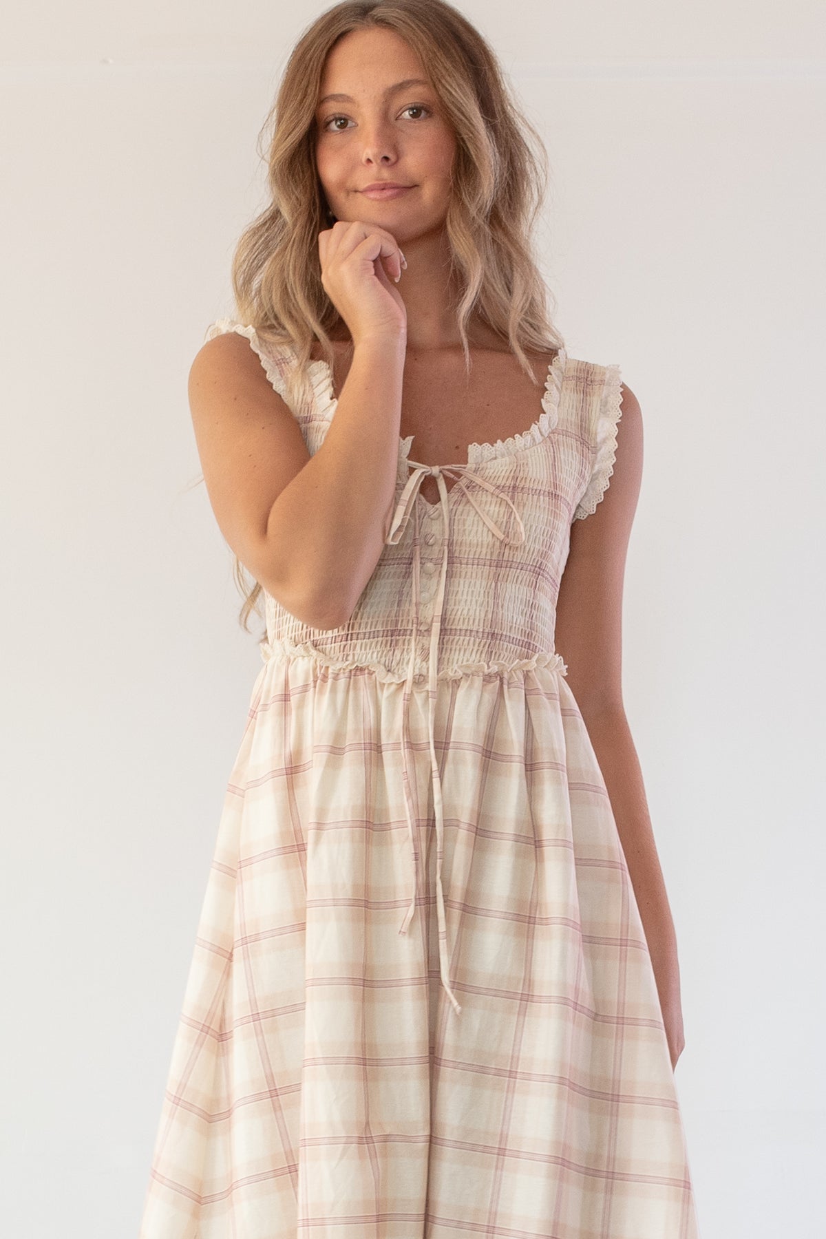 Beige plaid cotton dress, close up detail of the smocked bodice and tie front.