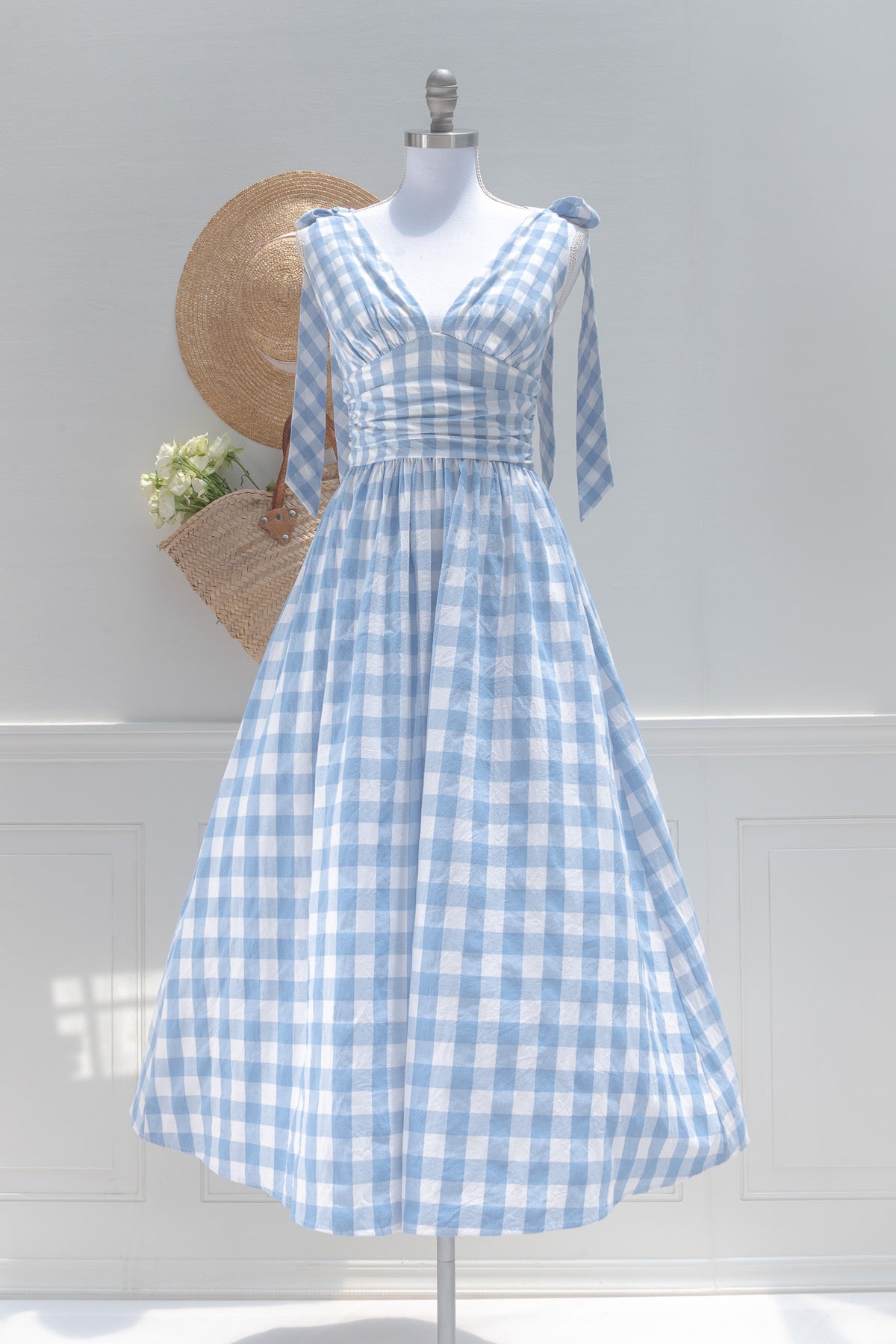 Blue and white gingham midi dress, shown on a mannequin, front view.