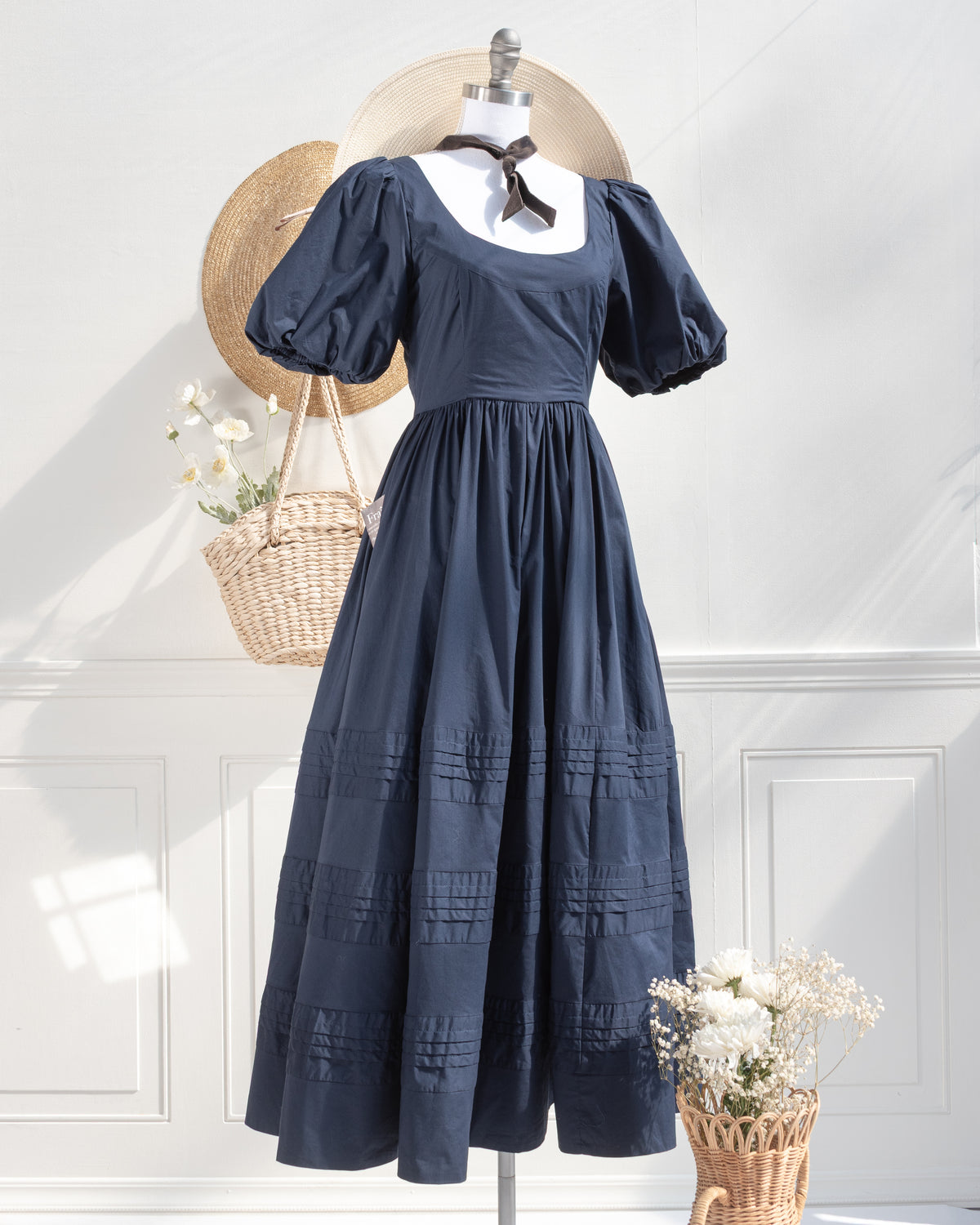 Feminine blue dress with puff sleeves, full skirt, and round neckline. Romantic French style from Amantine. 