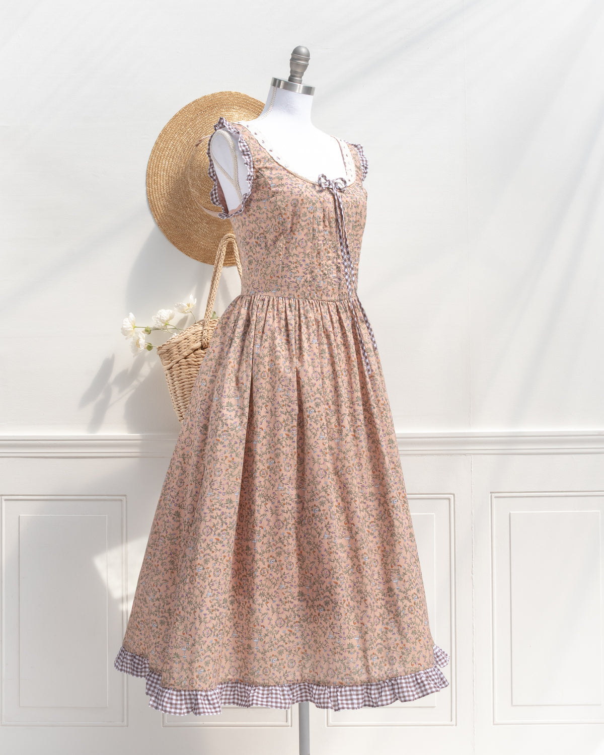 Blush floral print corset back dress shown on a mannequin, three quarter view.