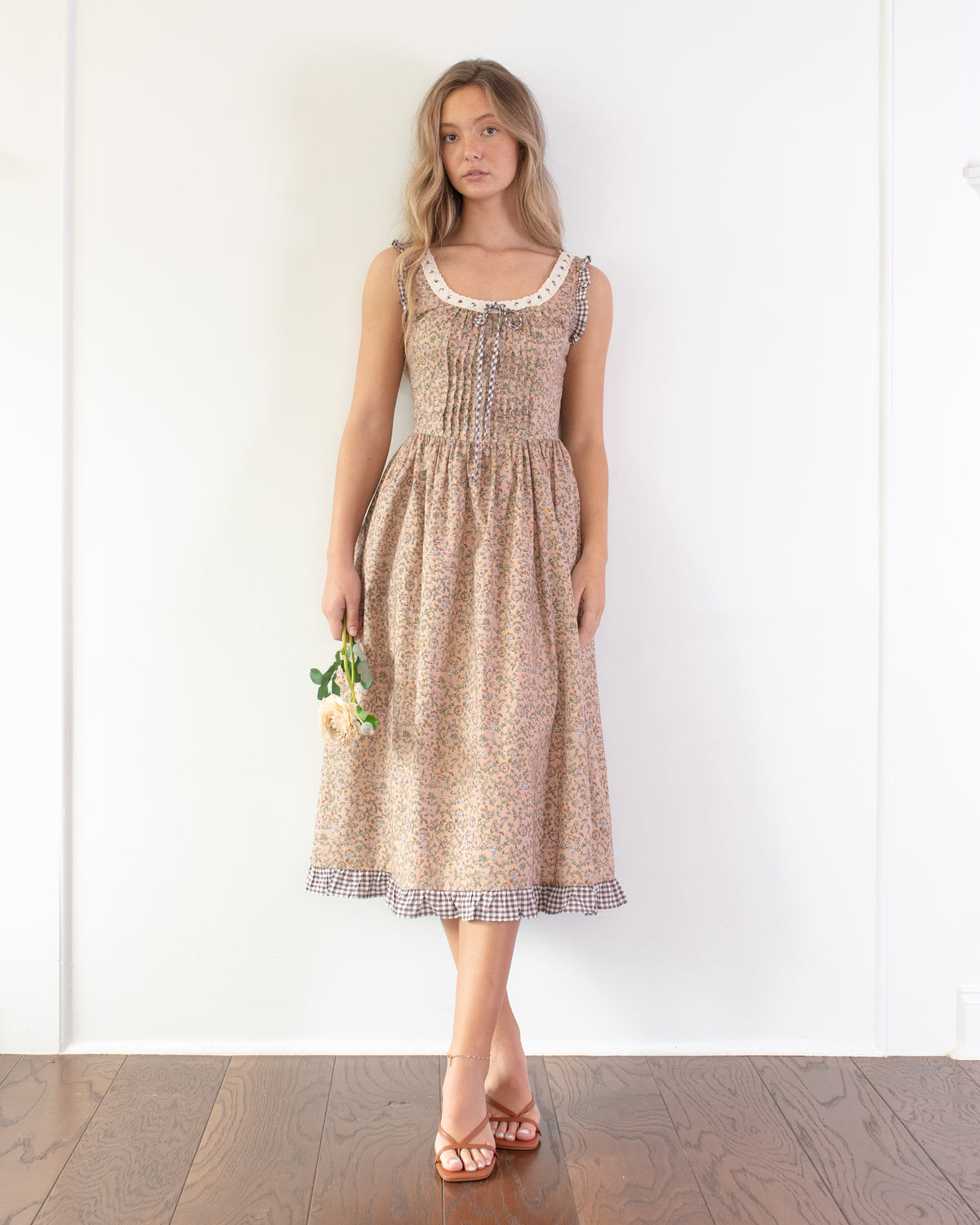 Blush floral print corset back dress worn by a model, front view.