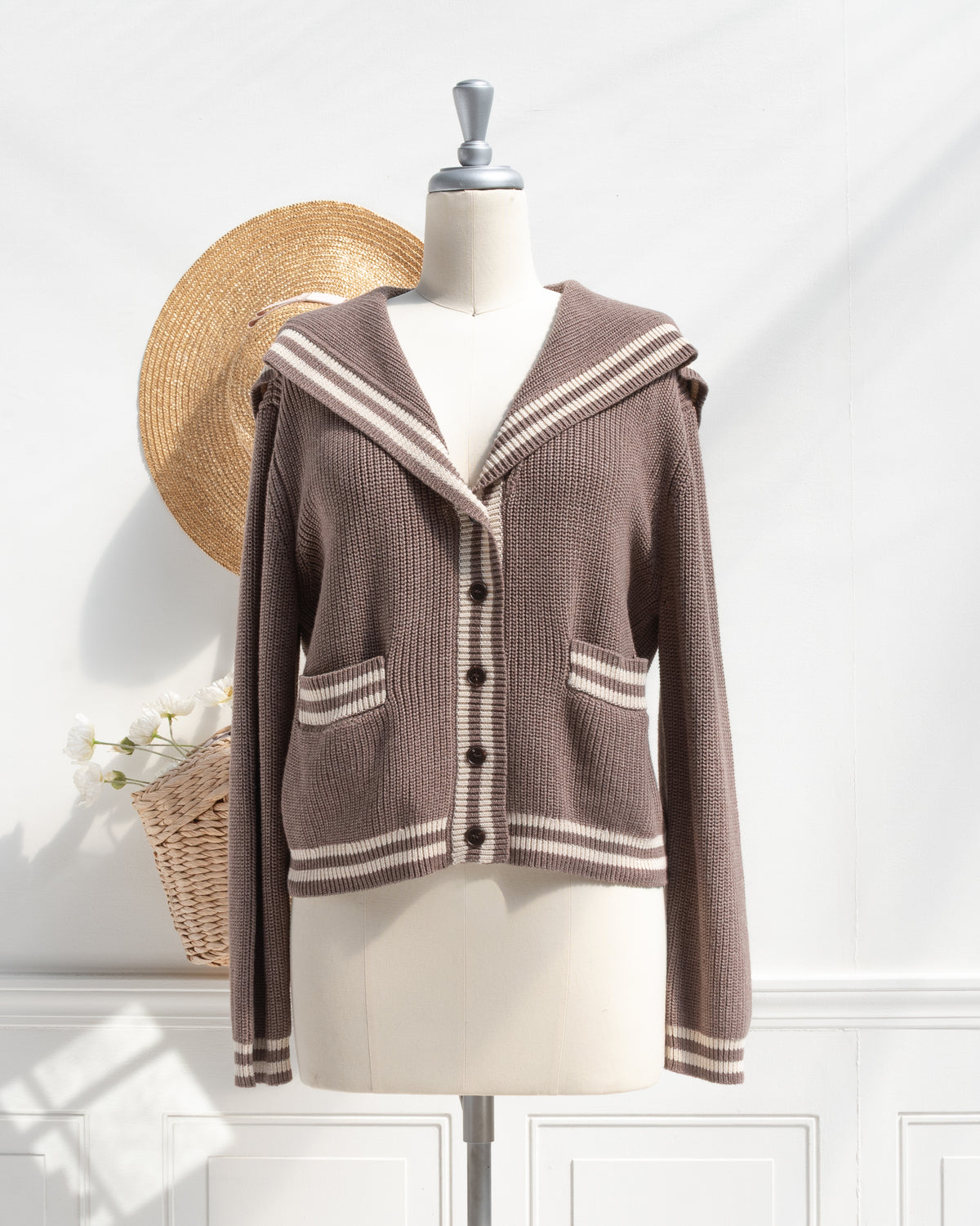 Feminine brown striped cardigan with sailor collar shown on a mannequin, front view.