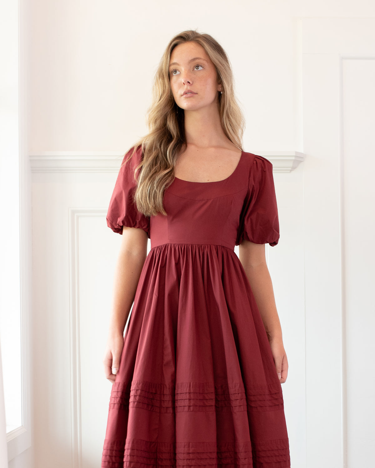 Close view of the Felicity Dress bodice in burgundy cotton, showing the scoop neck, puff sleeves, and gathered high waist in a feminine style.