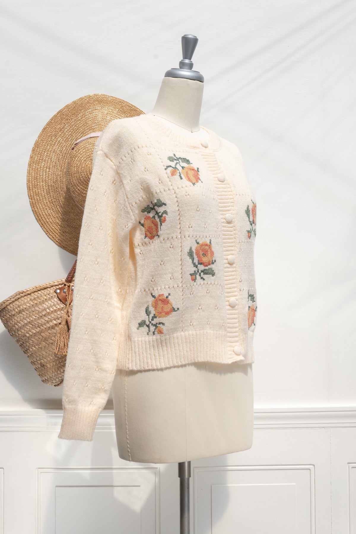Buttercream knit rose cardigan, a French girl essential, with floral embroidery, three-quarter view.