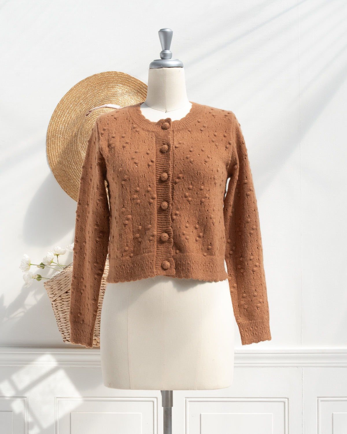 Caramel pointelle cardigan shown on a mannequin, front view.