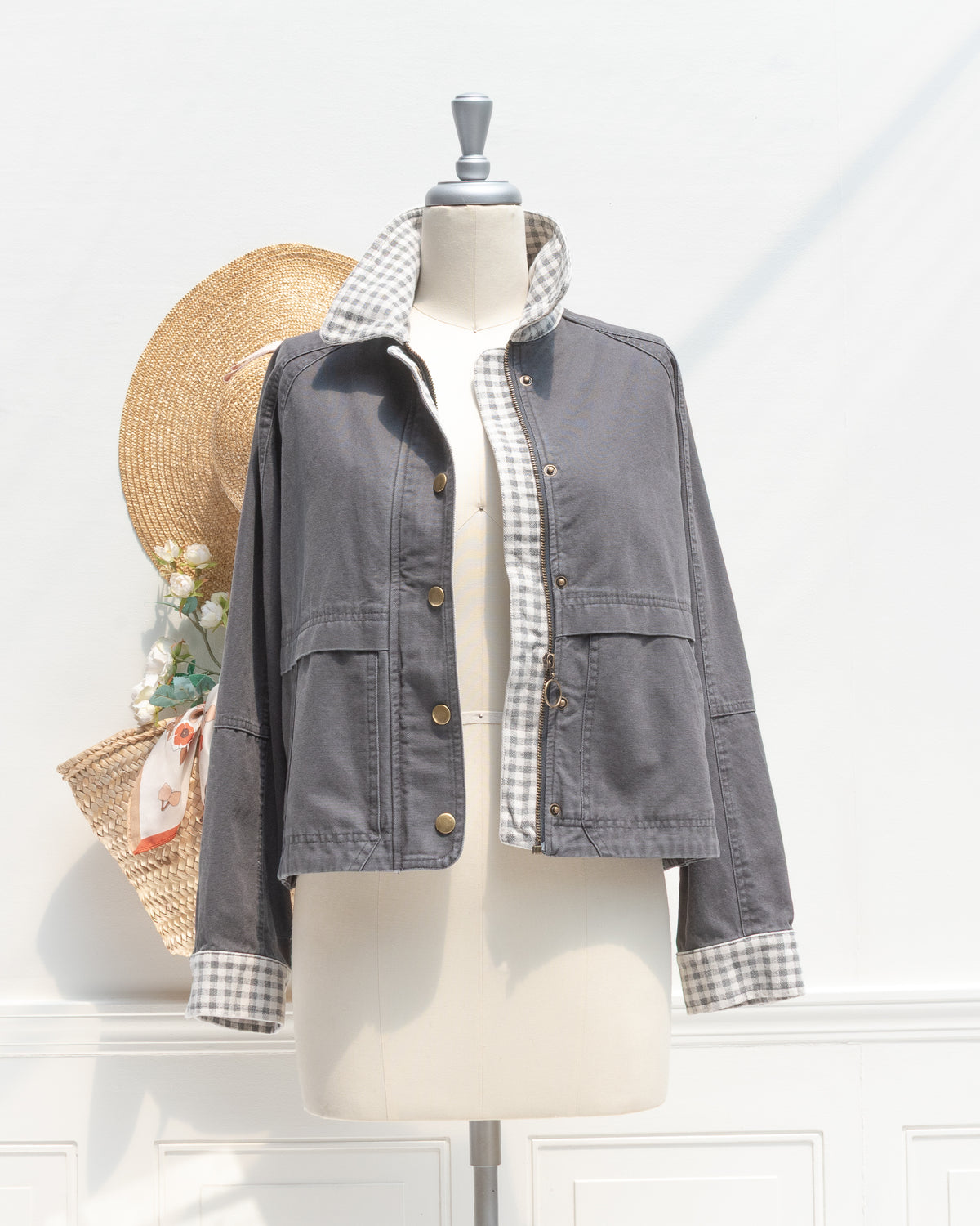 Charcoal cotton chore jacket worn open to show the zipper and gingham placket, mannequin front view.
