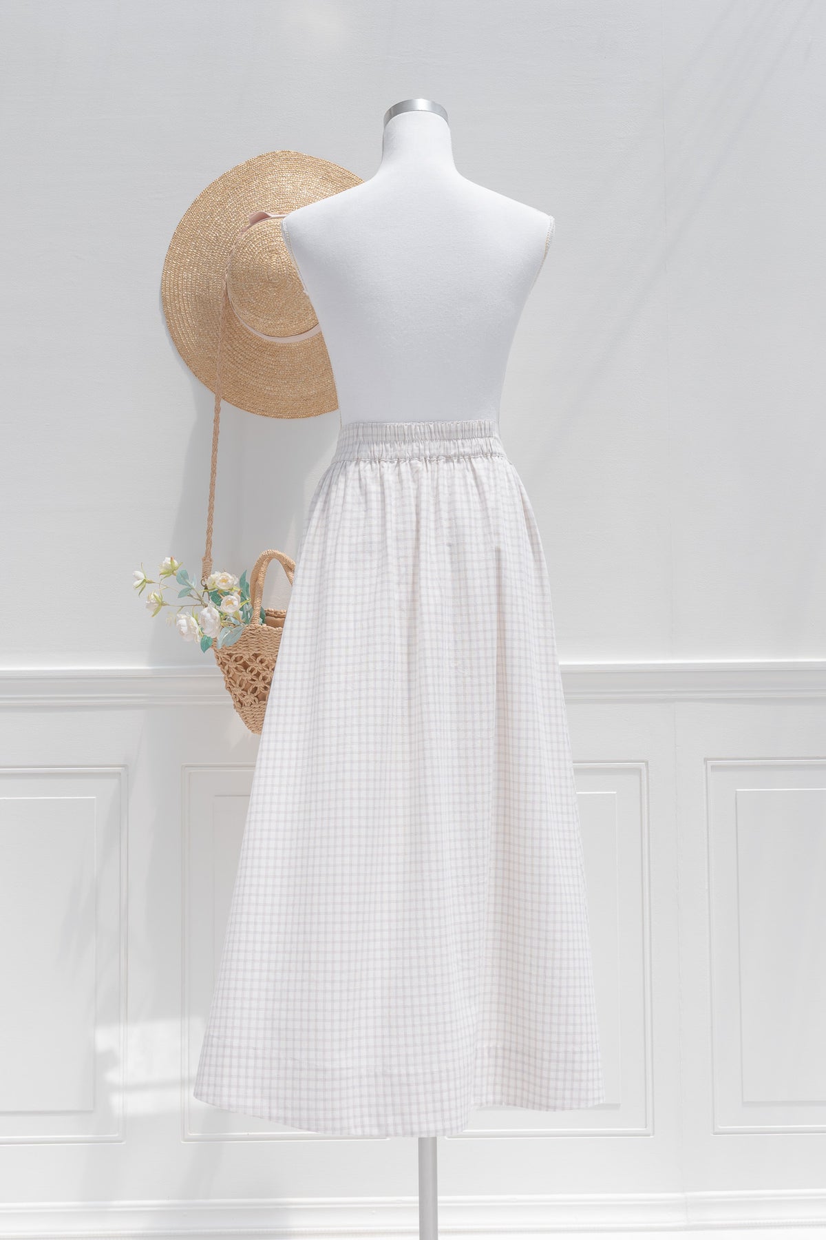 White cotton check midi skirt showing half elastic waistband and clean back silhouette, back view.