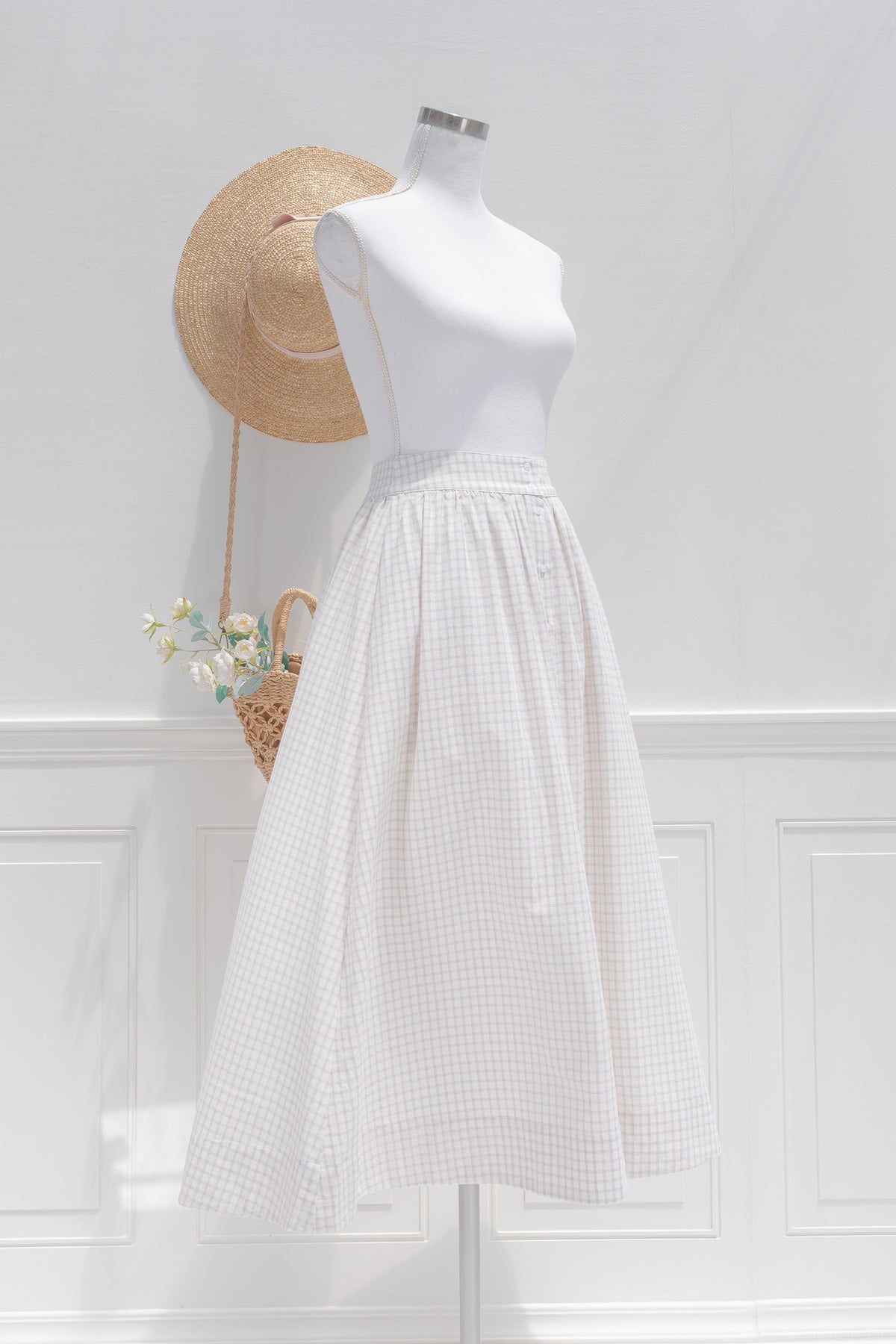 French style white cotton check midi skirt showing A-line silhouette and full skirt volume, three quarter view.