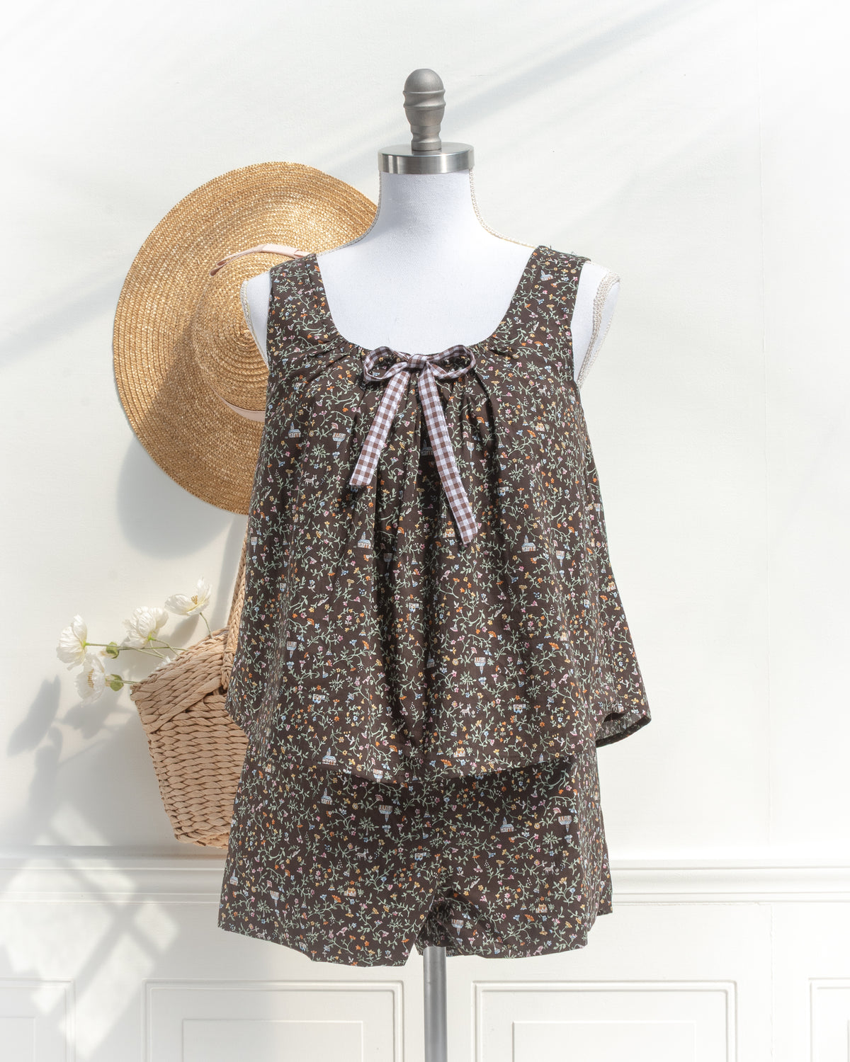 Chocolate brown floral print lounge set with gingham bow detail, mannequin front view.