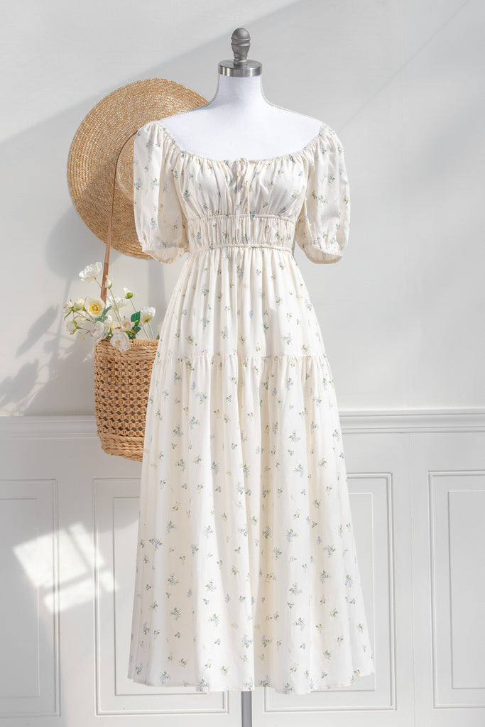 Cottagecore dress. A cute floral cottagecore style dress perfect for spring. Short sleeves, elastic bodice, square neckline, elastic shoulders. worn off shoulder view. Amantine. 