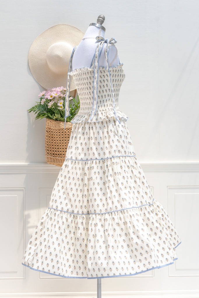 cotton floral summer dress with bow straps. cream floral with light blue trim. perfect romantic french girl style outfit idea. back side view. amantine dresses. 