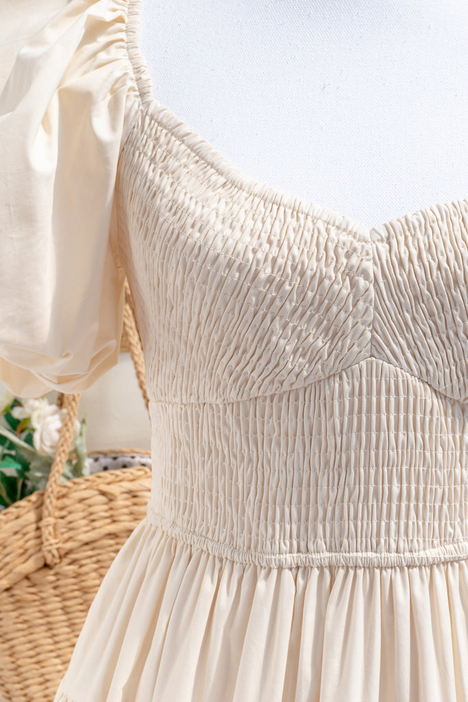 cottagecore dresses collection. a beautiful cottage core style dress with a sweetheart neckline, short puff sleeves, ruched bodice, side seam pockets, and a line skirt. perfect for easter and spring. front view showing ruching on bodice area. amantine. 