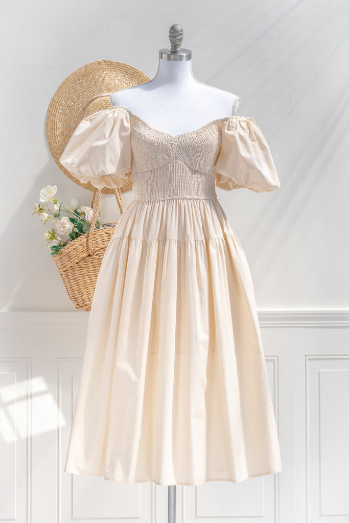 cottagecore dresses collection. a beautiful cottage core style dress with a sweetheart neckline, short puff sleeves, ruched bodice, side seam pockets, and a line skirt. perfect for easter and spring. front view showing styled off the shoulder. amantine. 