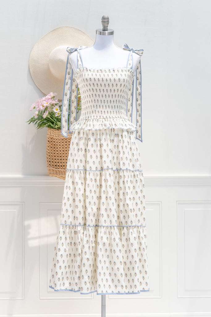 cotton floral summer dress with bow straps. cream floral with light blue trim. perfect romantic french girl style outfit idea. Front view. amantine dresses. 
