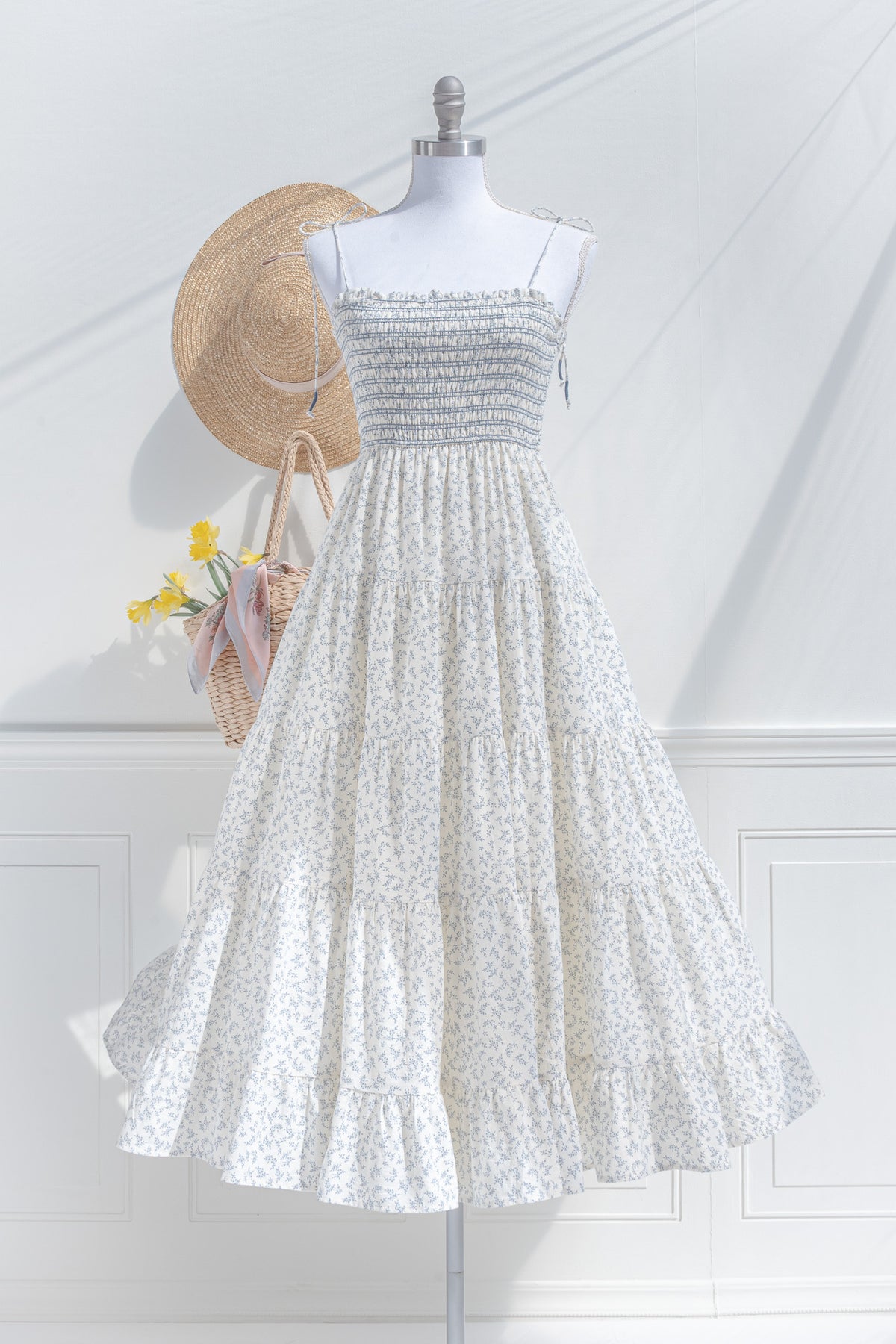 Ivory cotton maxi dress with blue floral print and smocked bodice — front view