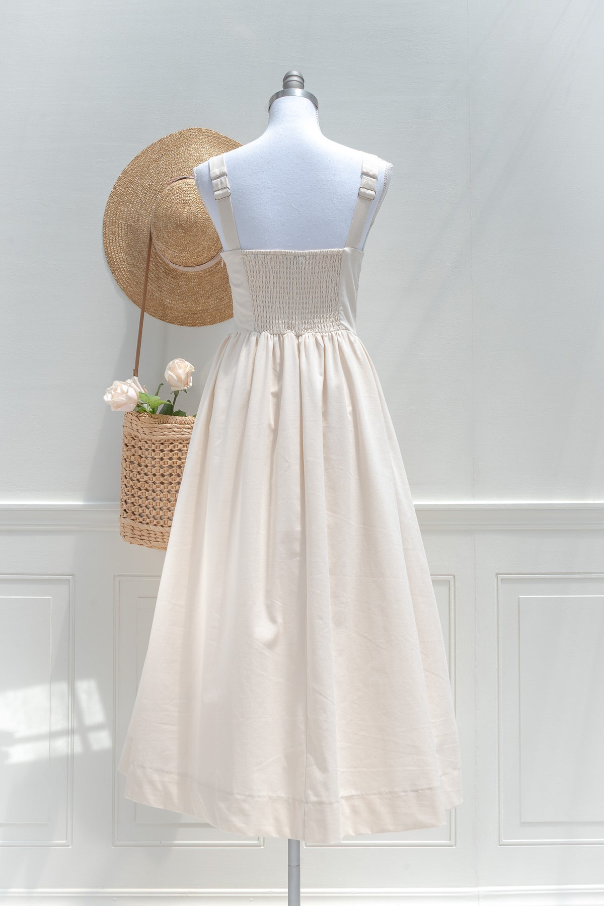 Cream cotton midi dress with smocked elastic back and adjustable shoulder straps back view.