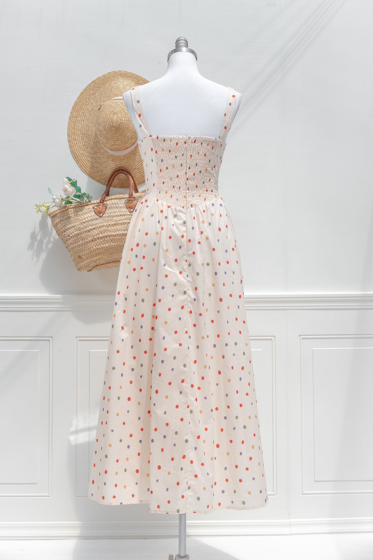 Cream polka dot cotton midi dress with smocked elastic back and gathered waist back view.