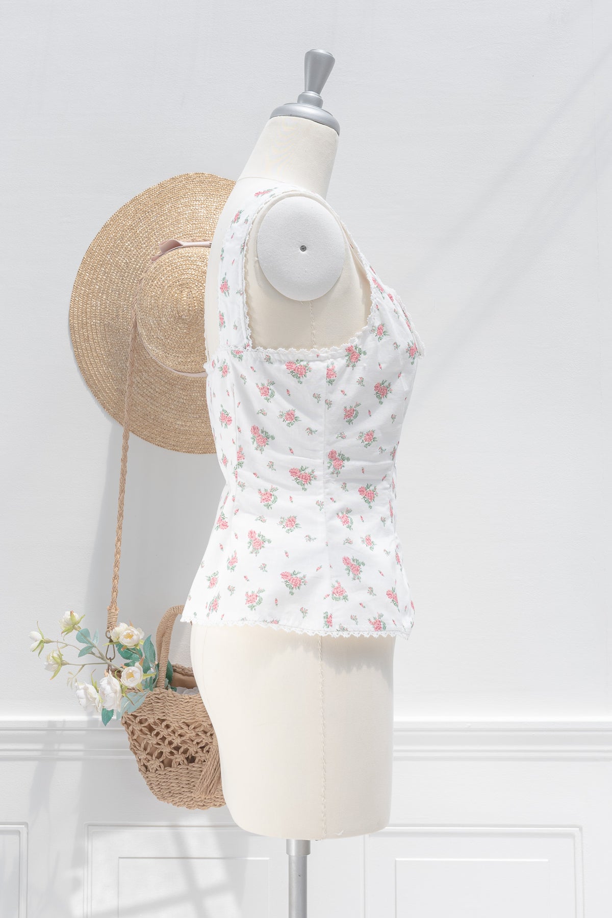 White floral linen cotton bustier top showing structured silhouette and scalloped lace hem, side view.