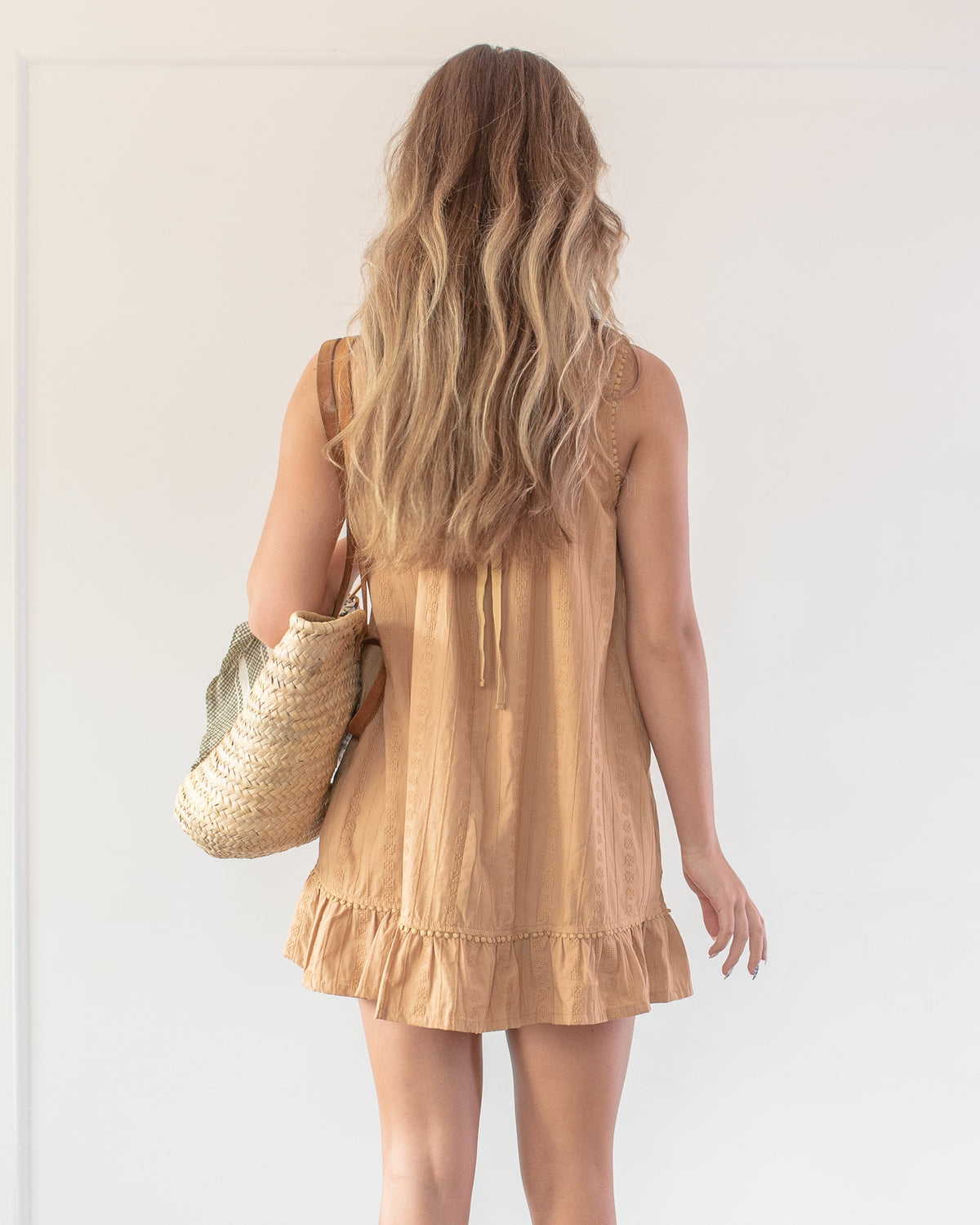 Cotton mini dress for an effortlessly feminine outfit made for early autumn days. styled on model, back view. Amantine