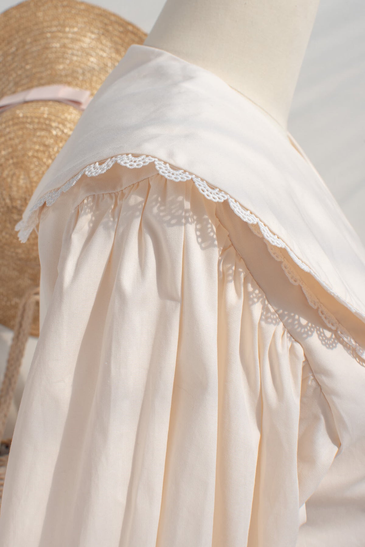 Close-up of lace-trimmed oversized collar on Éloise cream blouse