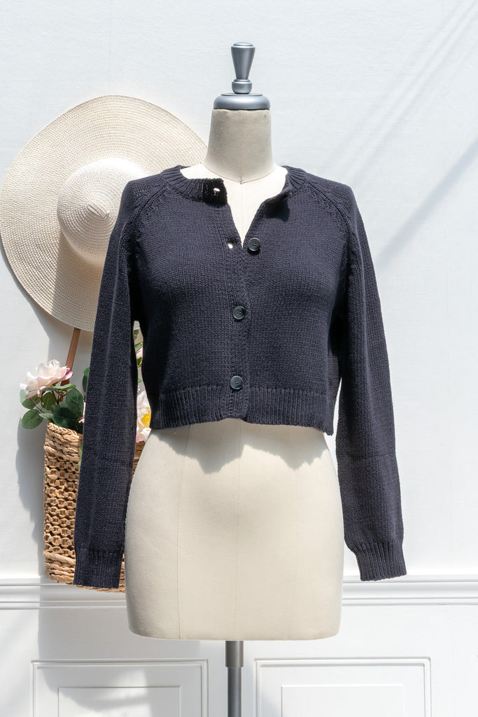 Navy blue cardigan on a mannequin with a white background